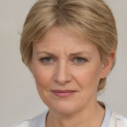 Joyful white adult female with medium  brown hair and blue eyes