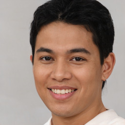 Joyful asian young-adult male with short  brown hair and brown eyes