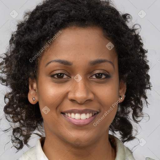 Joyful black young-adult female with long  brown hair and brown eyes