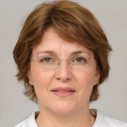 Joyful white adult female with medium  brown hair and green eyes