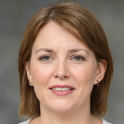 Joyful white adult female with medium  brown hair and grey eyes