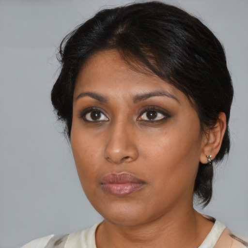 Neutral black young-adult female with medium  brown hair and brown eyes