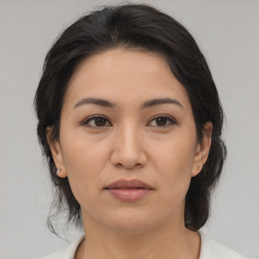 Joyful asian young-adult female with medium  brown hair and brown eyes