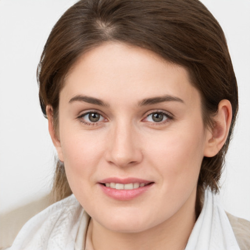 Joyful white young-adult female with medium  brown hair and grey eyes