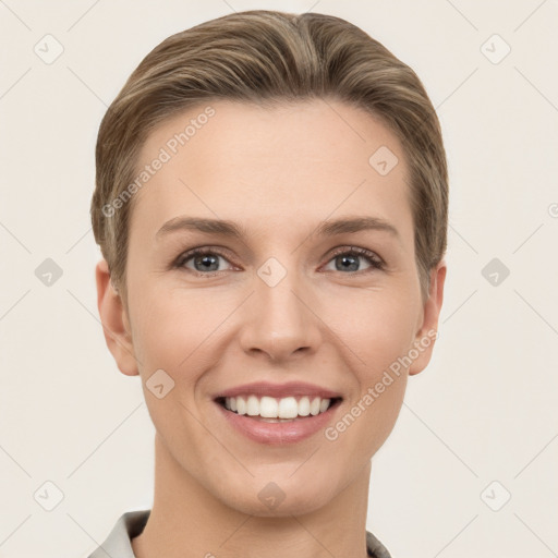 Joyful white young-adult female with short  brown hair and grey eyes