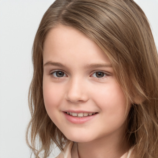 Joyful white child female with long  brown hair and brown eyes