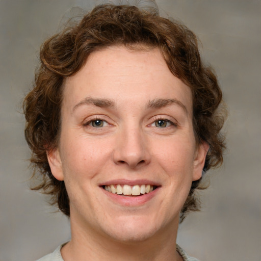 Joyful white young-adult female with medium  brown hair and green eyes