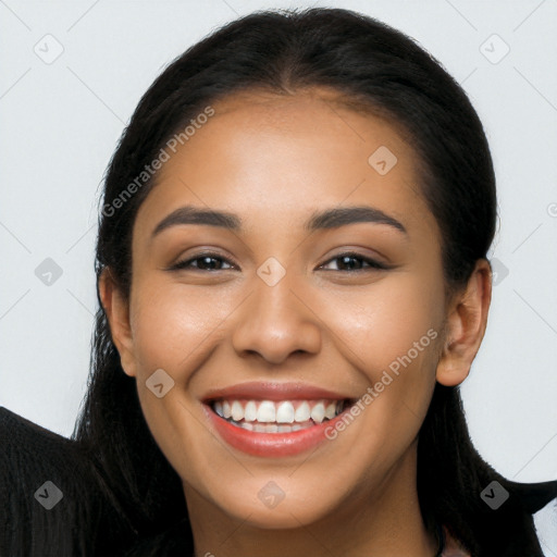 Joyful latino young-adult female with long  brown hair and brown eyes