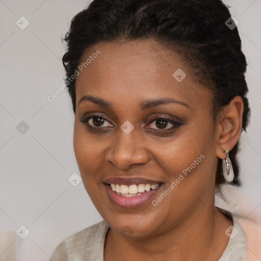 Joyful black young-adult female with short  brown hair and brown eyes