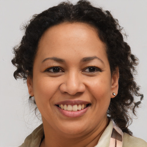 Joyful latino adult female with medium  brown hair and brown eyes