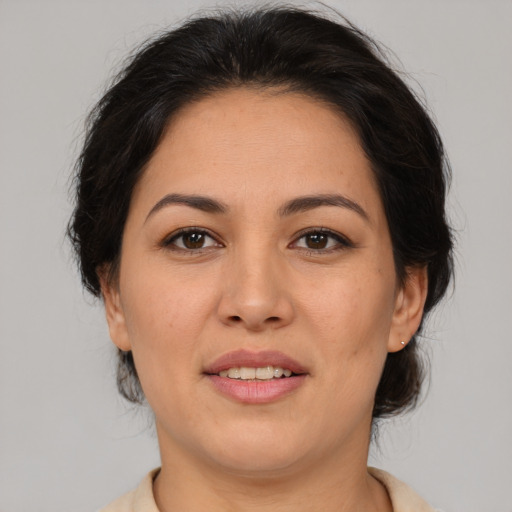 Joyful latino adult female with medium  brown hair and brown eyes