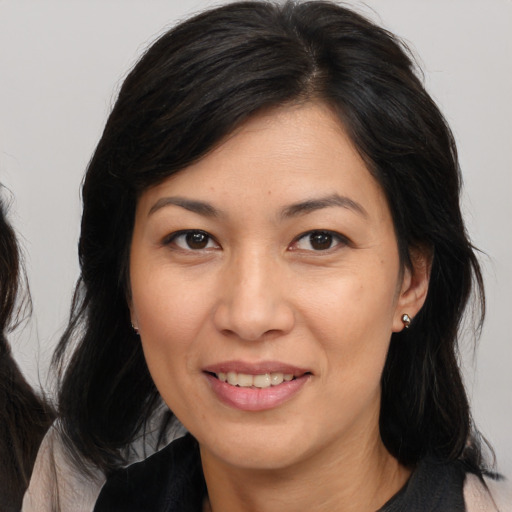 Joyful white adult female with medium  brown hair and brown eyes