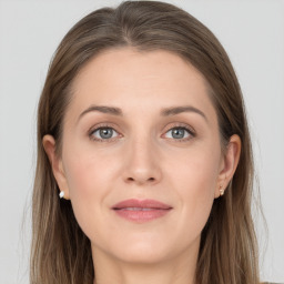 Joyful white young-adult female with long  brown hair and grey eyes