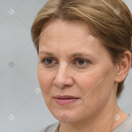 Joyful white adult female with medium  brown hair and grey eyes