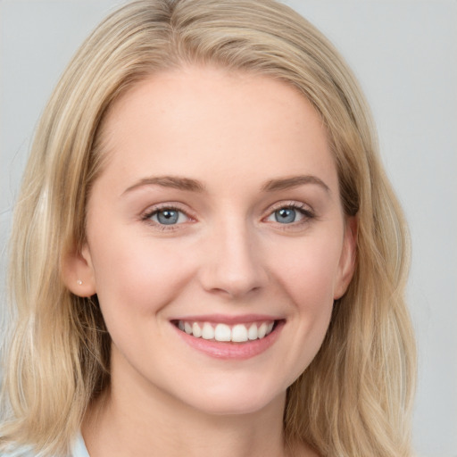 Joyful white young-adult female with long  brown hair and blue eyes