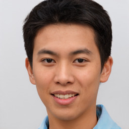 Joyful asian young-adult male with short  brown hair and brown eyes