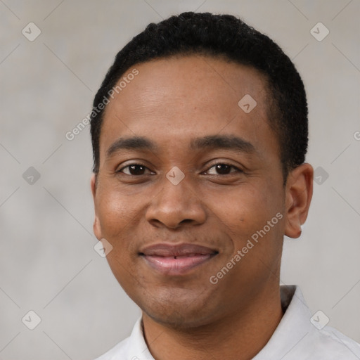 Joyful black young-adult male with short  black hair and brown eyes