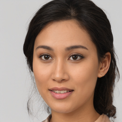 Joyful asian young-adult female with medium  brown hair and brown eyes