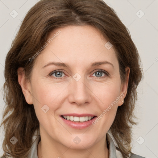 Joyful white adult female with medium  brown hair and grey eyes