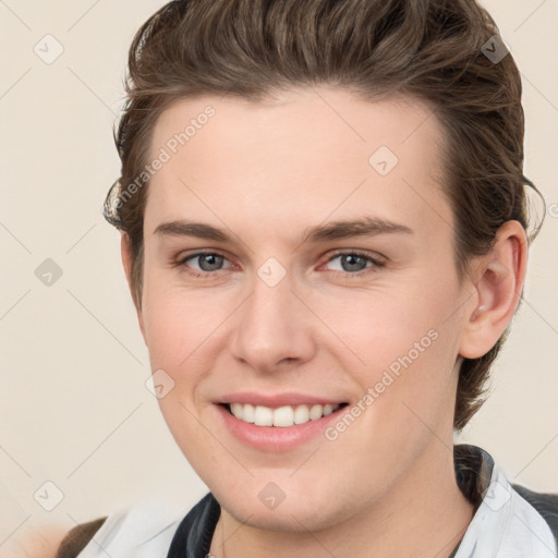 Joyful white young-adult female with short  brown hair and grey eyes