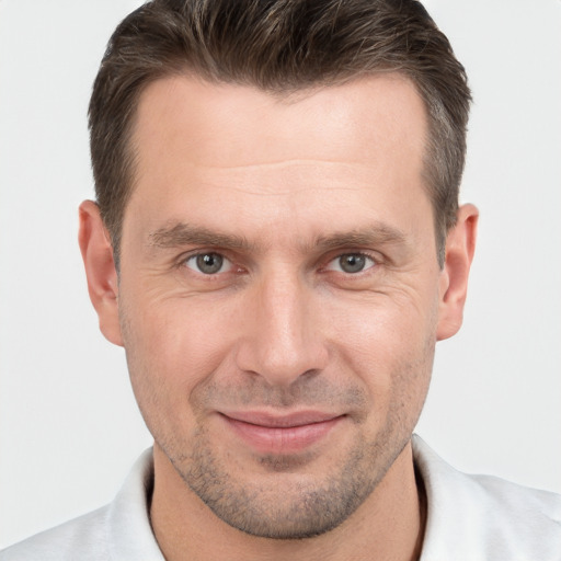 Joyful white adult male with short  brown hair and brown eyes