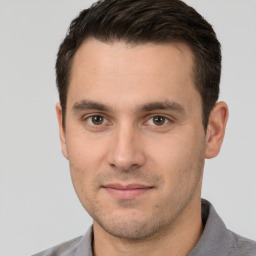 Joyful white young-adult male with short  brown hair and brown eyes