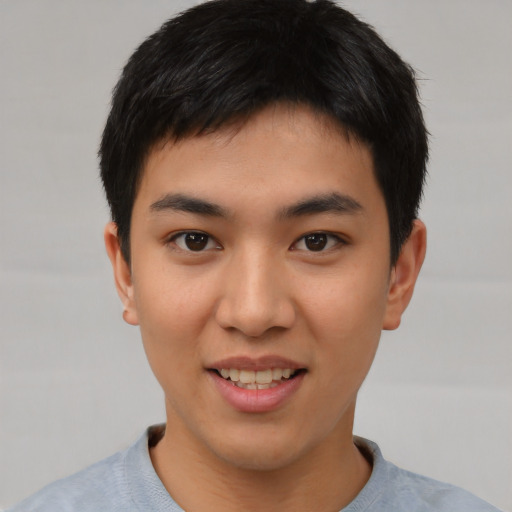 Joyful asian young-adult male with short  black hair and brown eyes
