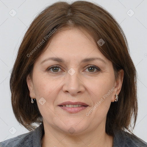 Joyful white adult female with medium  brown hair and grey eyes