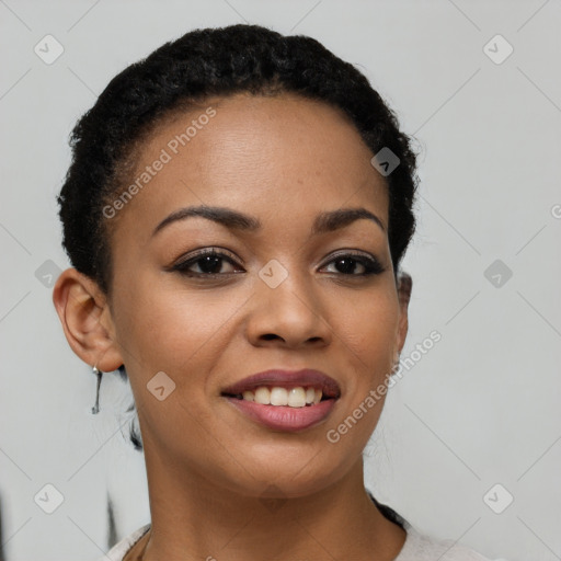 Joyful black young-adult female with short  brown hair and brown eyes