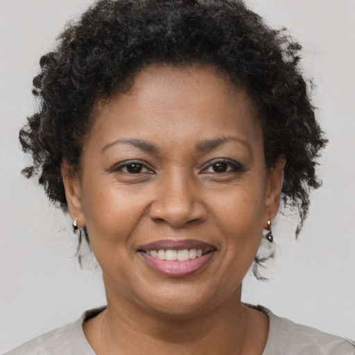 Joyful black adult female with short  brown hair and brown eyes