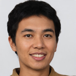 Joyful asian young-adult male with short  black hair and brown eyes