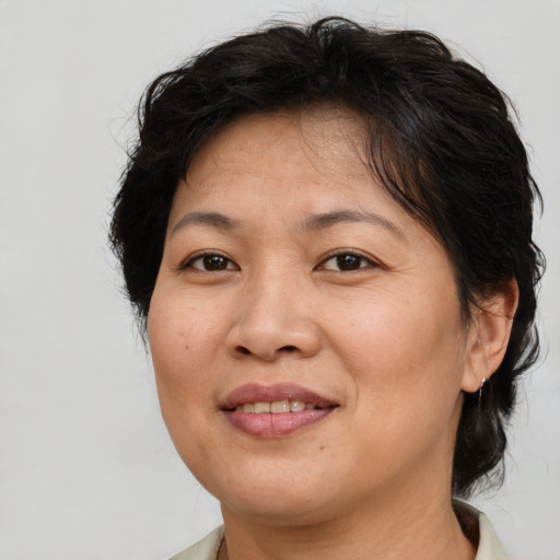 Joyful asian adult female with medium  brown hair and brown eyes