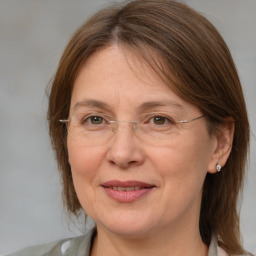 Joyful white adult female with medium  brown hair and grey eyes