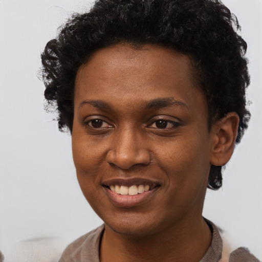 Joyful black young-adult female with short  brown hair and brown eyes