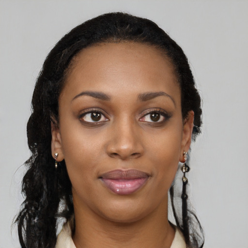 Joyful black young-adult female with long  black hair and brown eyes
