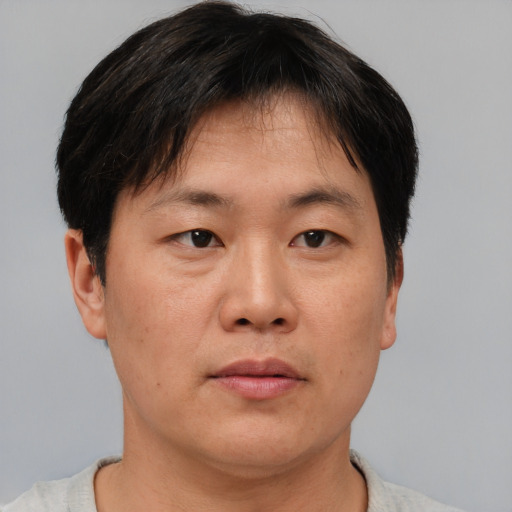 Neutral asian adult male with short  brown hair and brown eyes
