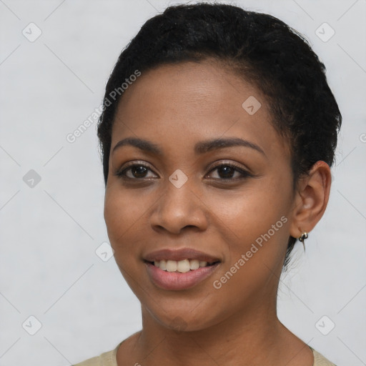 Joyful black young-adult female with short  black hair and brown eyes