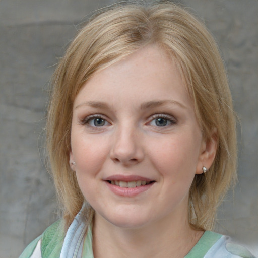 Joyful white young-adult female with medium  brown hair and blue eyes