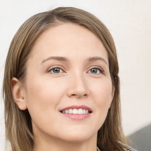 Joyful white young-adult female with long  brown hair and grey eyes