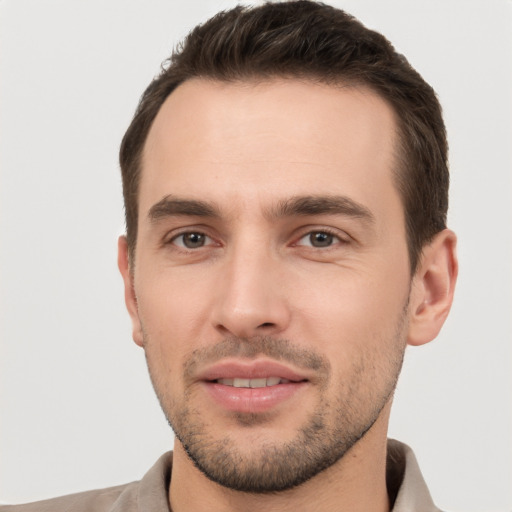 Joyful white young-adult male with short  brown hair and brown eyes