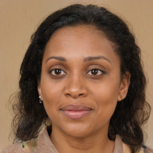 Joyful latino adult female with medium  brown hair and brown eyes