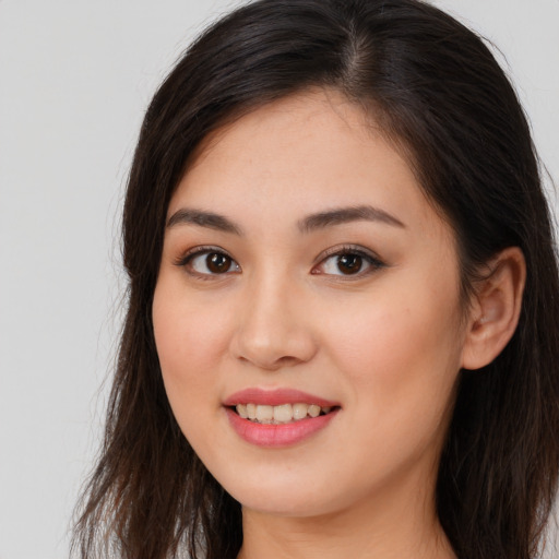 Joyful white young-adult female with long  brown hair and brown eyes