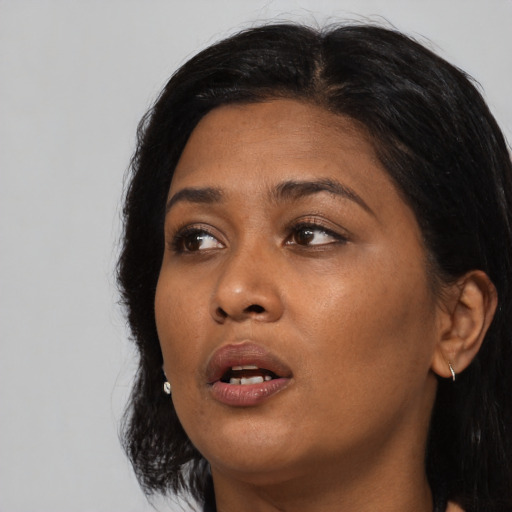 Neutral asian adult female with medium  black hair and brown eyes