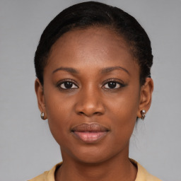 Joyful black young-adult female with short  brown hair and brown eyes