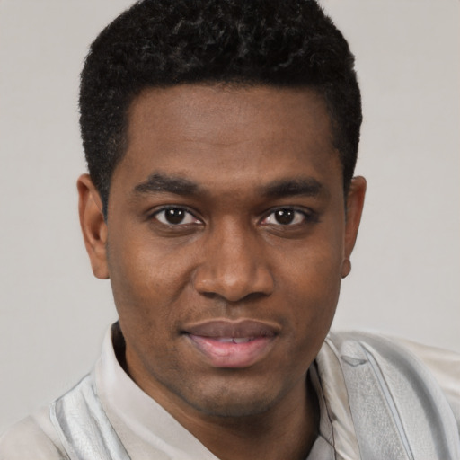 Joyful black young-adult male with short  black hair and brown eyes