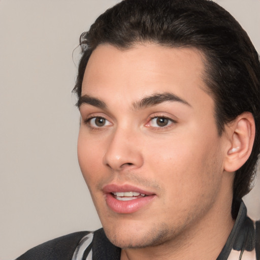 Joyful white young-adult male with short  black hair and brown eyes