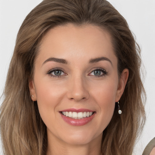 Joyful white young-adult female with long  brown hair and grey eyes