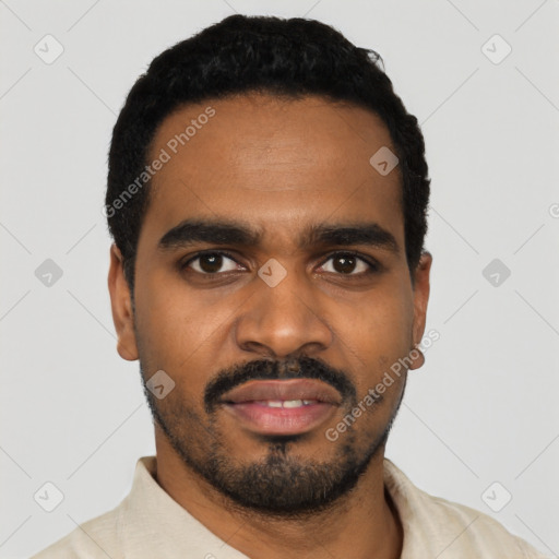 Joyful black young-adult male with short  black hair and brown eyes