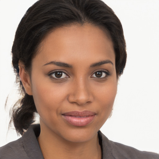 Joyful latino young-adult female with long  brown hair and brown eyes