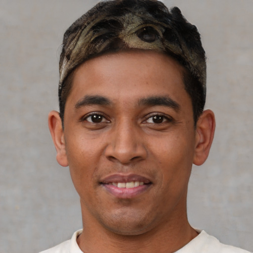 Joyful white young-adult male with short  black hair and brown eyes